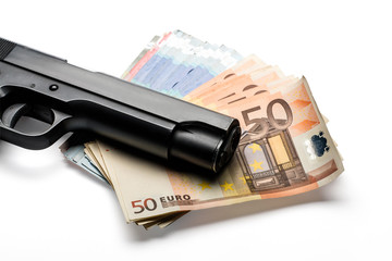 Bunch of euro banknotes with a gun