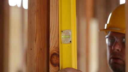 Construction worker checking level - Powered by Adobe