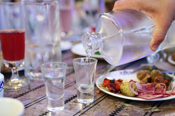 Waiter filling vodka