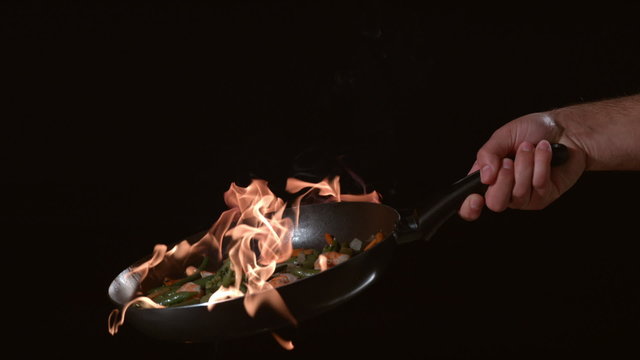 Flaming stirfry in slow motion
