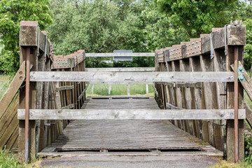 locked wooden bridge / Locked wooden bridge with trees and lawn