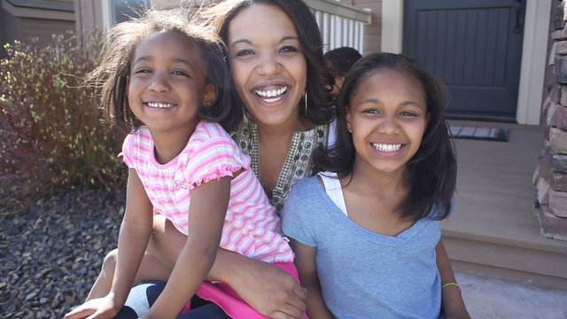 Portrait of happy African American mother and daughters 