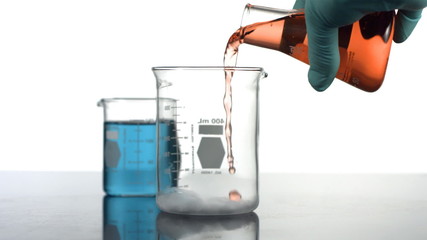 Liquid being poured into beaker. Slow motion. - Powered by Adobe