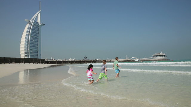 DUBAI, UNITED ARAB EMIRATES - Children play at Jumeirah beach (Model Released)