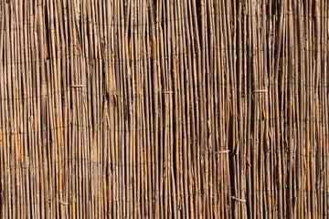 A wooden background with vertical reeds