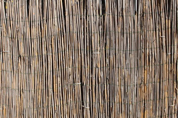 A wooden background with vertical reeds