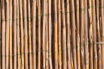 A wooden background with vertical reeds