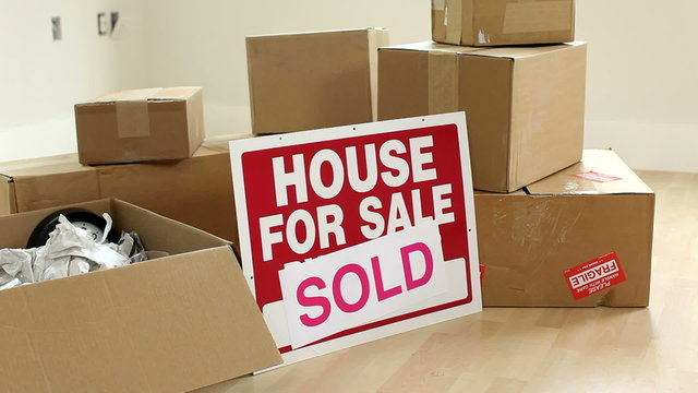 Cardboard boxes and sold sign