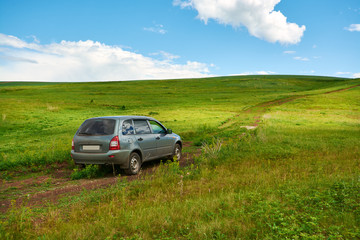 Fototapeta na wymiar Cars driving on a dirt road to the top of the hill