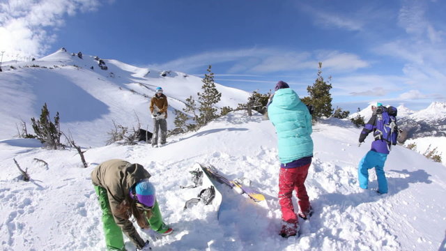 Group of snowboarders having snowball fight
