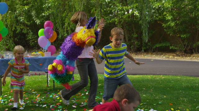 Boy hitting a pinata at party