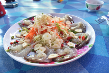 Shrimp in fish sauce with chilli and garlic on dish.