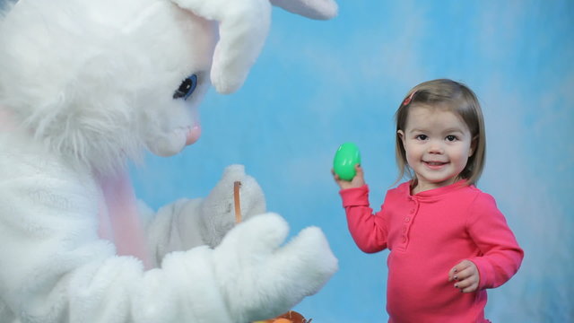 Easter bunny gives eggs to child