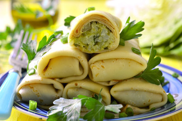 Pancakes stuffed with fried cabbage and greens.