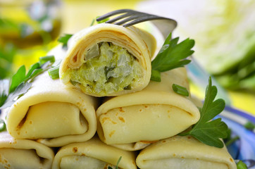 Pancakes stuffed with fried cabbage and greens.