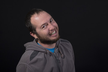young man smiling isolated on black background