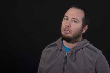 sad man isolated on black background