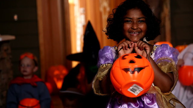 Young girl holding Halloween pail
