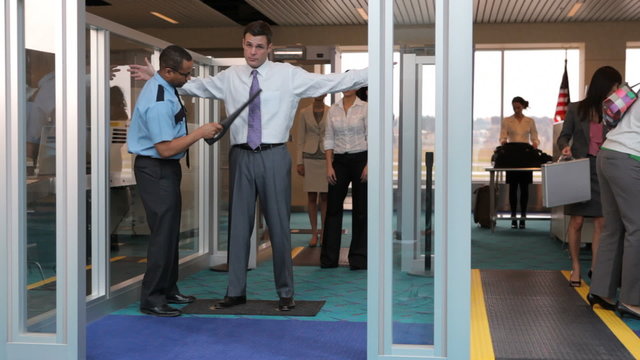 Travelers are screened at airport security checkpoint