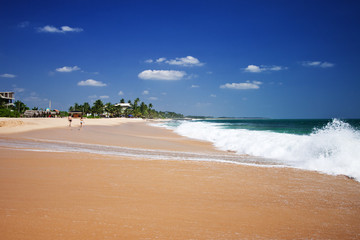 Untouched tropical beach with fishing boat in Sri Lanka