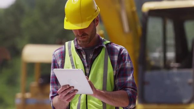 Construction worker looking over plans