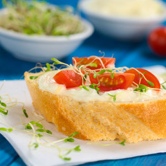 Baguette, cream cheese, cherry tomato and alfalfa sprouts