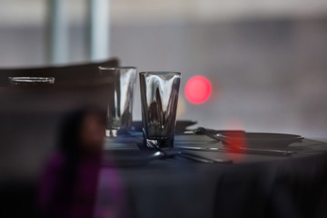 Dinner table setup with empty glass.