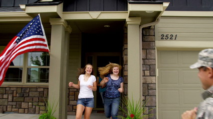Family runs out to greet soldier