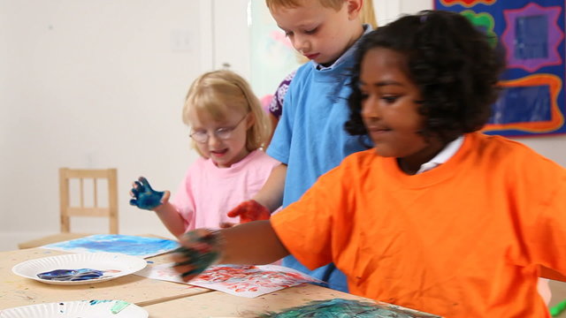 Preschool children finger painting