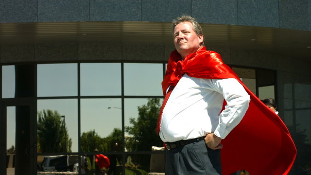 Businessman wearing superhero cape