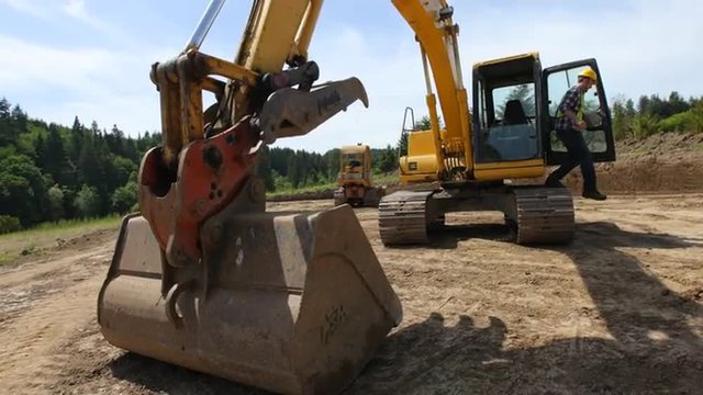 Construction workers work with excavation equipment