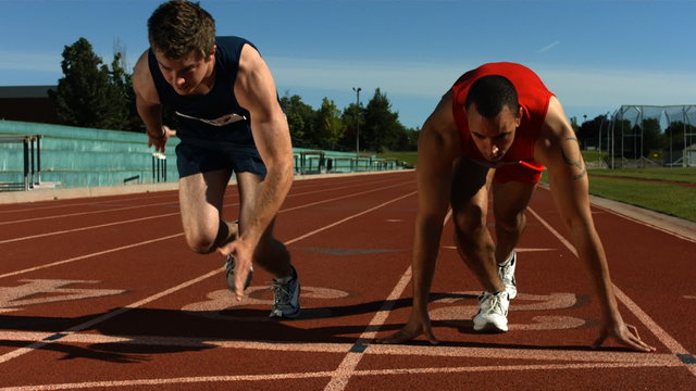 Track runners at starting line, slow motion