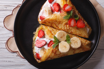 crepes with strawberries and bananas  closeup horizontal top view
