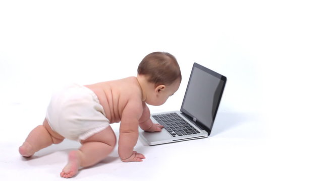 Baby on white background with laptop computer