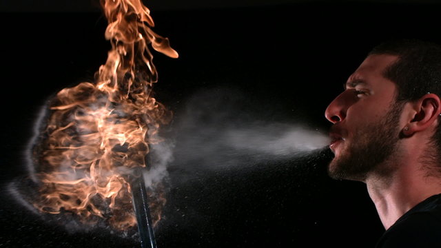 Man breathing fire, close up, slow motion