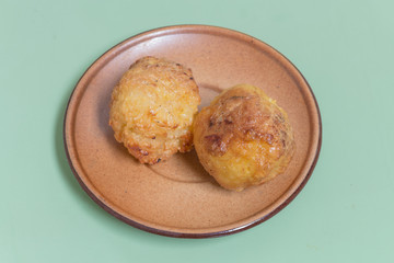 grilled sticky rice made into balls dip to egg on the brown dish