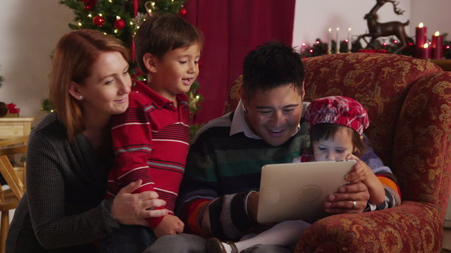 Family looking at digital tablet together during holidays