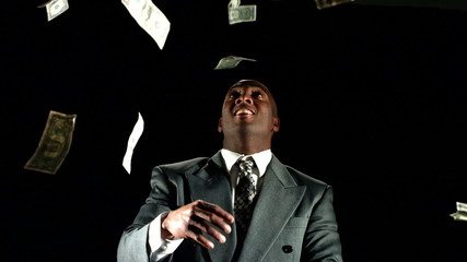 Money falling on businessman - Powered by Adobe