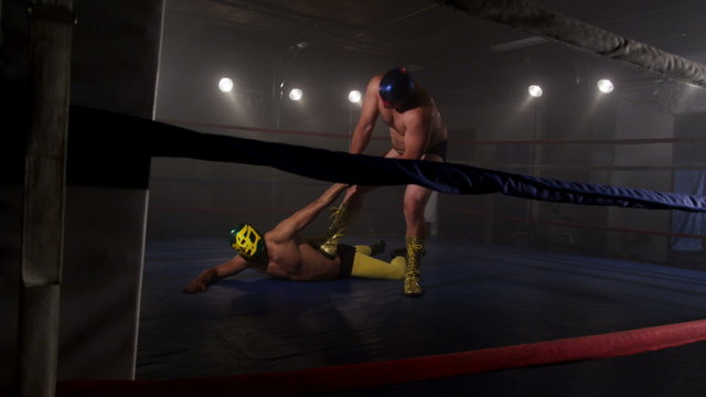 Masked wrestler attempts to tap out