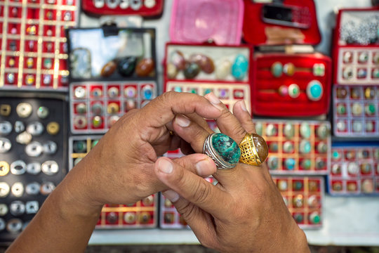 Man choosing ring on the market of Indonesia