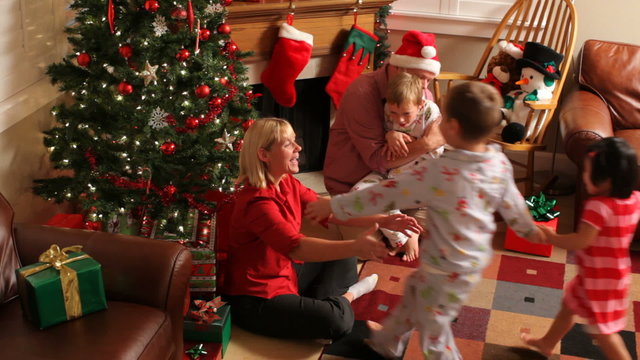Family passing out presents on Christmas morning