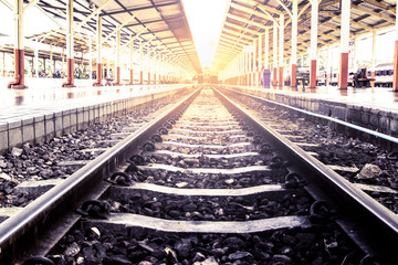 Fototapeta na wymiar railway track in train station in vintage color filter