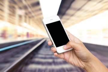 woman hand hold smart phone, tablet,cellphone on blurred of rail