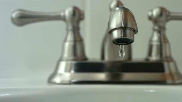 Water drips from faucet, slow motion