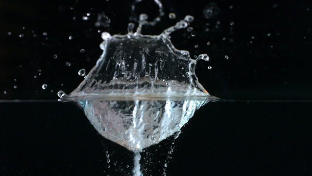 Orange splashing into water