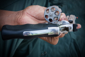 hand man holding show gun emptied storage cylinder of revolver handgun