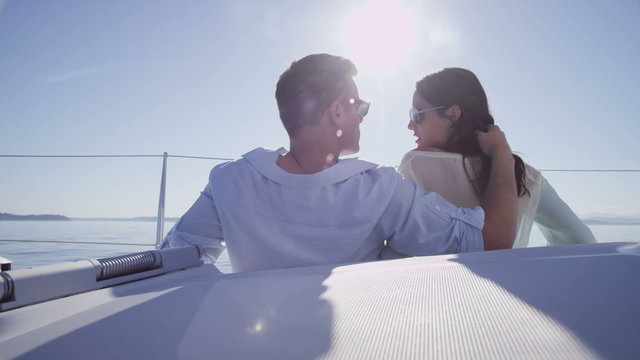 Young couple on sailboat together. 