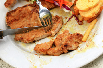 Pork chop, french fries with salad