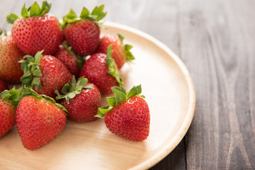 Fresh red strawberries on old wooden background