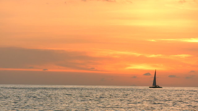 Sailboat on the ocean at sunset